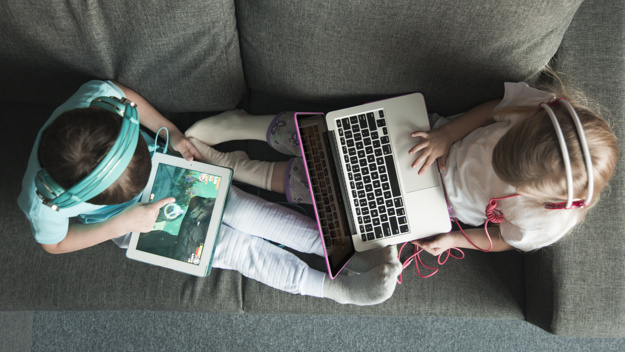 Top View Of Two Kids With Laptop And Tablet 23 2147782800